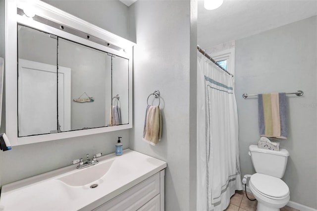 320 Broadway, Dunedin, FL 34698 - bathroom with vanity, toilet, tile patterned floors, a shower with shower curtain, and baseboards