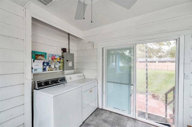 320 Broadway, Dunedin, FL 34698 - laundry room with washer and clothes dryer, ceiling fan, electric panel, and wood walls