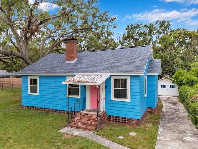 320 Broadway, Dunedin, FL 34698 - bungalow-style house featuring a chimney, roof with shingles, and an outdoor structure