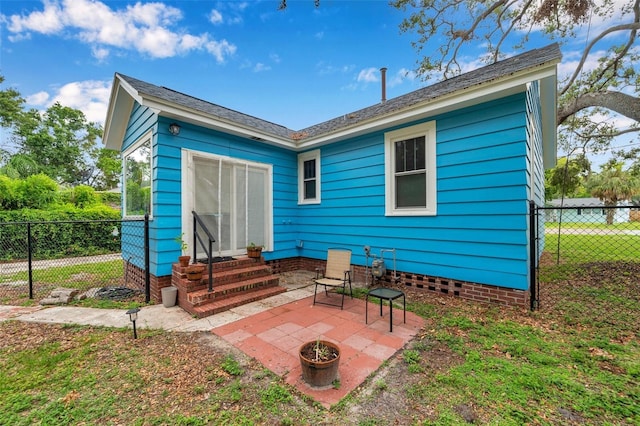320 Broadway, Dunedin, FL 34698 - rear view of property with entry steps and a patio
