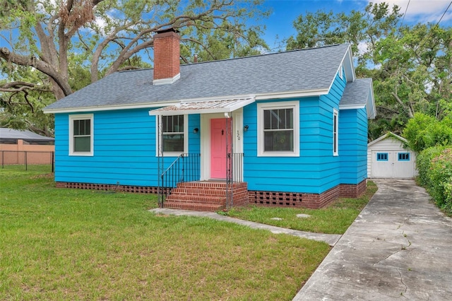 320 Broadway, Dunedin, FL 34698 - bungalow-style home featuring concrete driveway, a shingled roof, a chimney, and an outbuilding