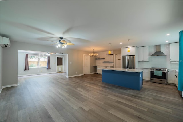 117 Connie Ave, Tampa, FL 33613 - kitchen featuring appliances with stainless steel finishes, wall chimney range hood, a ceiling fan, open floor plan, and an AC wall unit