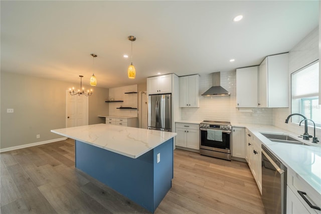 117 Connie Ave, Tampa, FL 33613 - kitchen with appliances with stainless steel finishes, wall chimney exhaust hood, a sink, backsplash, and a kitchen island