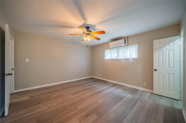 117 Connie Ave, Tampa, FL 33613 - unfurnished bedroom with a wall unit AC, wood finished floors, baseboards, and ceiling fan