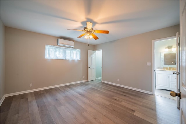 117 Connie Ave, Tampa, FL 33613 - empty room with an AC wall unit, a ceiling fan, wood finished floors, and baseboards