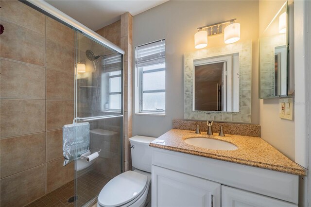 117 Connie Ave, Tampa, FL 33613 - bathroom featuring toilet, vanity, and a shower stall