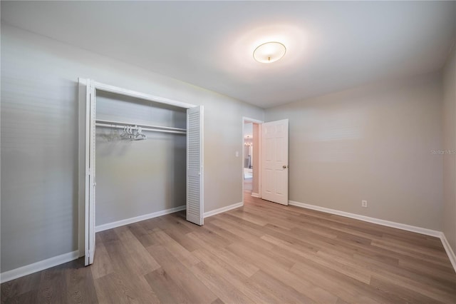 117 Connie Ave, Tampa, FL 33613 - unfurnished bedroom featuring wood finished floors, a closet, and baseboards