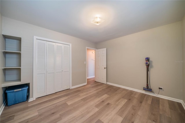 117 Connie Ave, Tampa, FL 33613 - unfurnished bedroom with wood finished floors, baseboards, and a closet