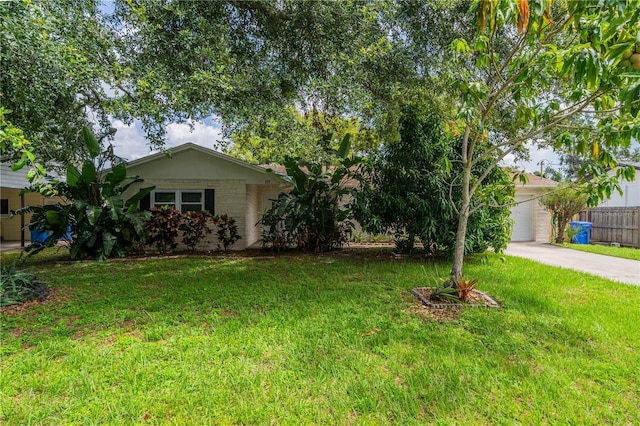 117 Connie Ave, Tampa, FL 33613 - view of front facade featuring a garage, brick siding, and driveway
