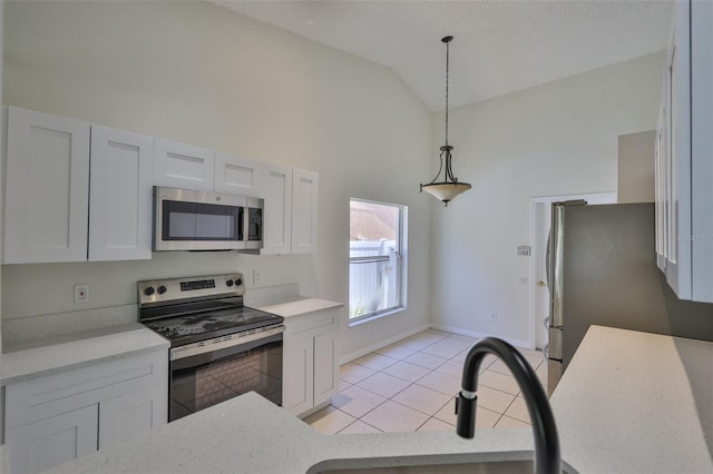 10414 Hallmark Blvd, Riverview, FL 33578 - kitchen featuring appliances with stainless steel finishes, light tile patterned flooring, high vaulted ceiling, decorative light fixtures, and a sink