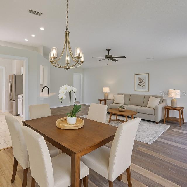 10414 Hallmark Blvd, Riverview, FL 33578 - dining room with recessed lighting, a chandelier, light wood-style flooring, a ceiling fan, and baseboards