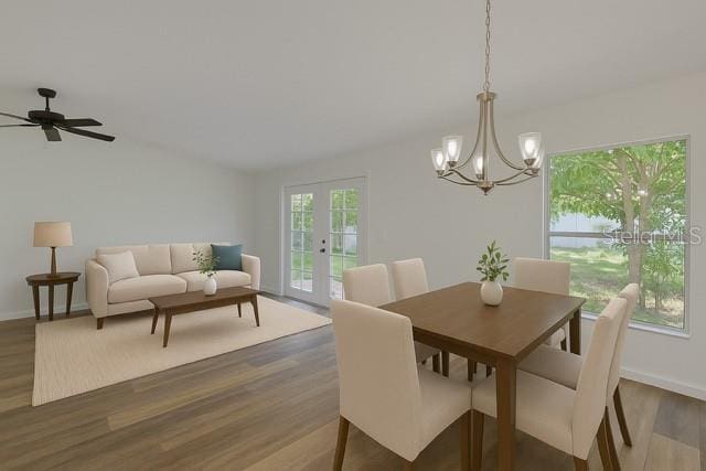 10414 Hallmark Blvd, Riverview, FL 33578 - dining area featuring a chandelier, dark wood finished floors, lofted ceiling, baseboards, and french doors