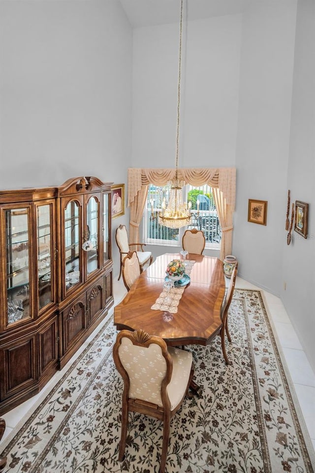 184 Hunter Ct, Palm Harbor, FL 34684 - dining room with a high ceiling, a chandelier, and light tile patterned floors