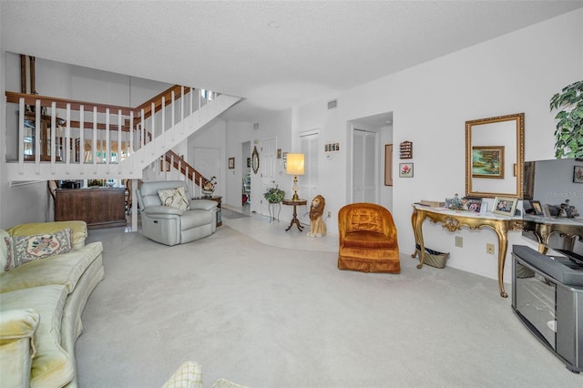 184 Hunter Ct, Palm Harbor, FL 34684 - living room featuring carpet flooring, stairway, and a textured ceiling