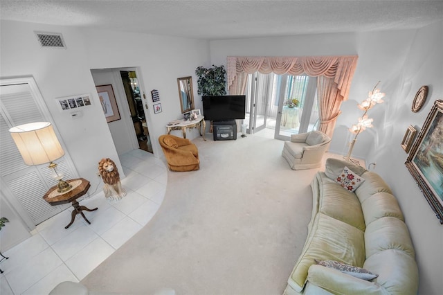 184 Hunter Ct, Palm Harbor, FL 34684 - living area featuring tile patterned floors, a textured ceiling, and carpet floors