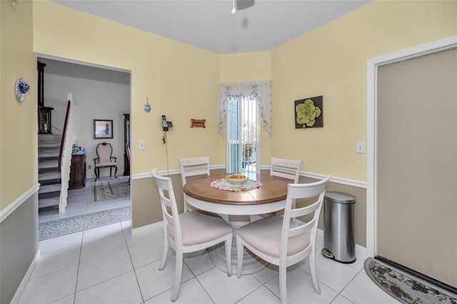 184 Hunter Ct, Palm Harbor, FL 34684 - dining area featuring stairs, light tile patterned flooring, baseboards, and a ceiling fan