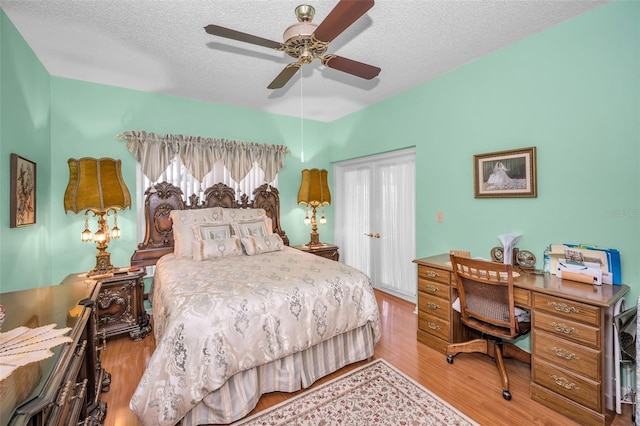 184 Hunter Ct, Palm Harbor, FL 34684 - bedroom with wood finished floors, a textured ceiling, ceiling fan, and a closet