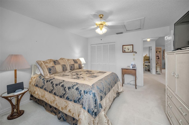 184 Hunter Ct, Palm Harbor, FL 34684 - bedroom with light carpet, a closet, attic access, ceiling fan, and a textured ceiling