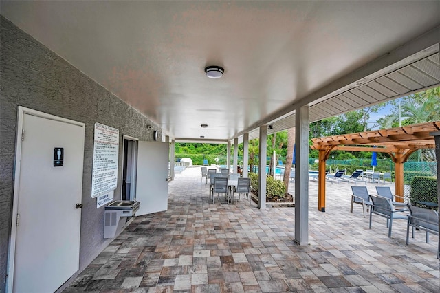 184 Hunter Ct, Palm Harbor, FL 34684 - view of patio / terrace with a pergola, outdoor dining area, and a community pool
