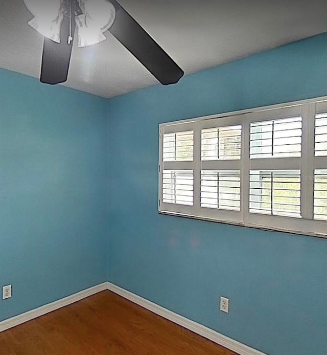 2523 Krueger Ln, Tampa, FL 33618 - unfurnished room featuring baseboards, wood finished floors, and a ceiling fan