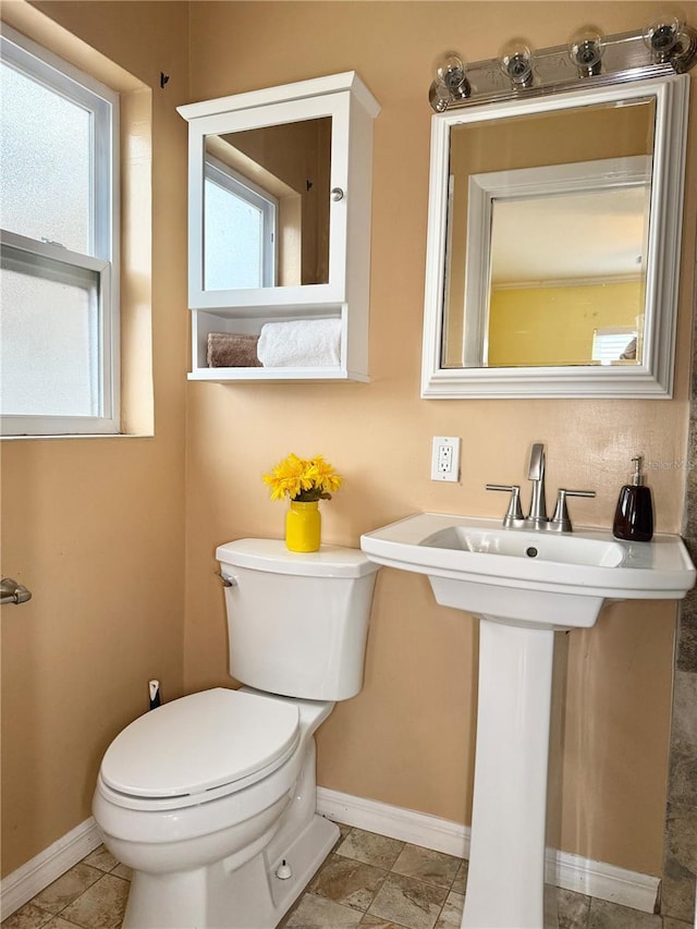 2523 Krueger Ln, Tampa, FL 33618 - half bathroom with toilet, baseboards, and a sink