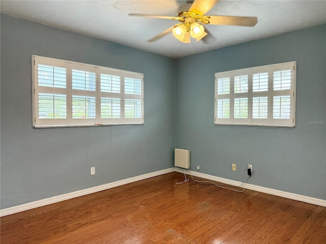 2523 Krueger Ln, Tampa, FL 33618 - spare room featuring a ceiling fan, wood finished floors, and baseboards