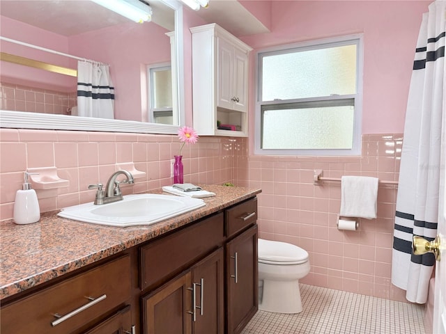 2523 Krueger Ln, Tampa, FL 33618 - bathroom featuring vanity, tile patterned flooring, tile walls, toilet, and a shower with curtain