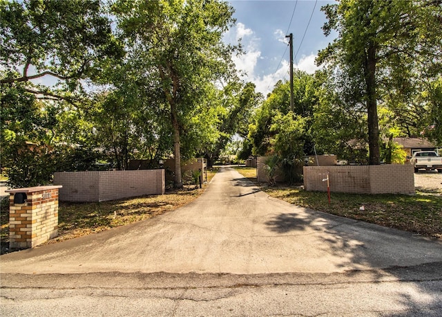 309 Hidden Lake Dr, Brandon, FL 33511 - view of asphalt driveway featuring a gated entry