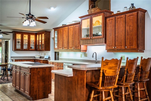 309 Hidden Lake Dr, Brandon, FL 33511 - kitchen with a ceiling fan, a peninsula, a sink, light countertops, and light tile patterned floors