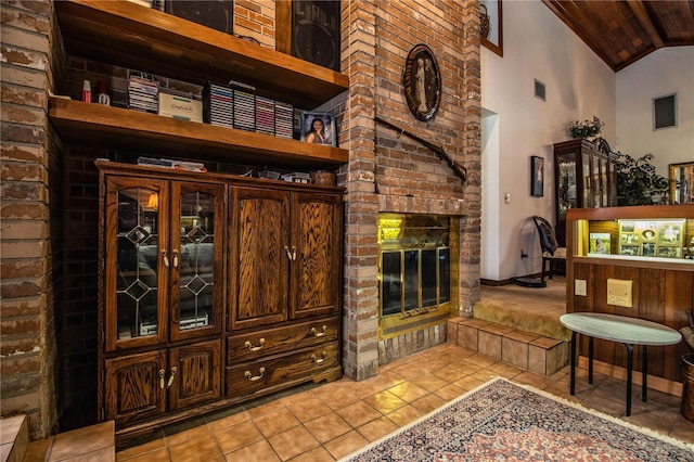 309 Hidden Lake Dr, Brandon, FL 33511 - living room with a fireplace, light tile patterned floors, wood ceiling, and high vaulted ceiling