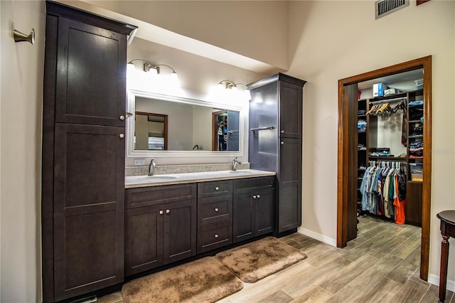 309 Hidden Lake Dr, Brandon, FL 33511 - full bath with double vanity, wood finish floors, and a spacious closet
