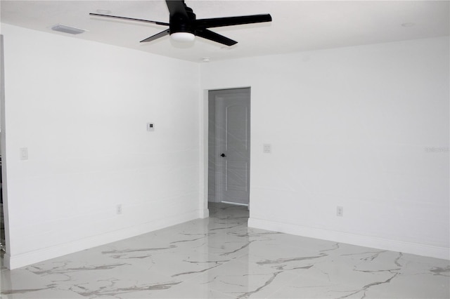 1109 N Obrien St, Tampa, FL 33607 - unfurnished room featuring a ceiling fan, baseboards, and marble finish floors