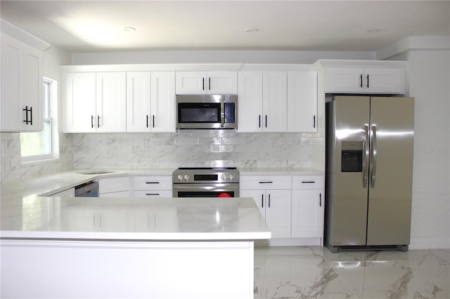 1109 N Obrien St, Tampa, FL 33607 - kitchen with appliances with stainless steel finishes, white cabinetry, backsplash, light countertops, and recessed lighting