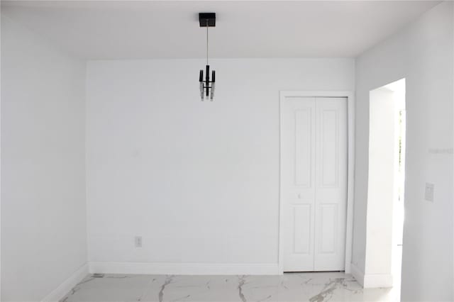 1109 N Obrien St, Tampa, FL 33607 - unfurnished dining area with light marble finish flooring and baseboards