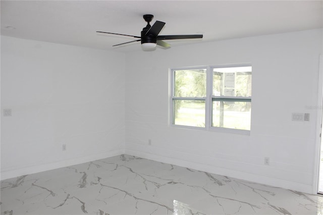 1109 N Obrien St, Tampa, FL 33607 - spare room with baseboards, marble look tiles, and ceiling fan