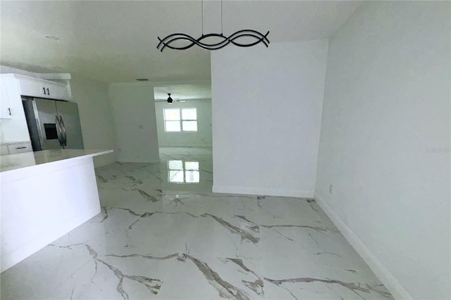 1109 N Obrien St, Tampa, FL 33607 - unfurnished dining area featuring baseboards and light marble finish flooring
