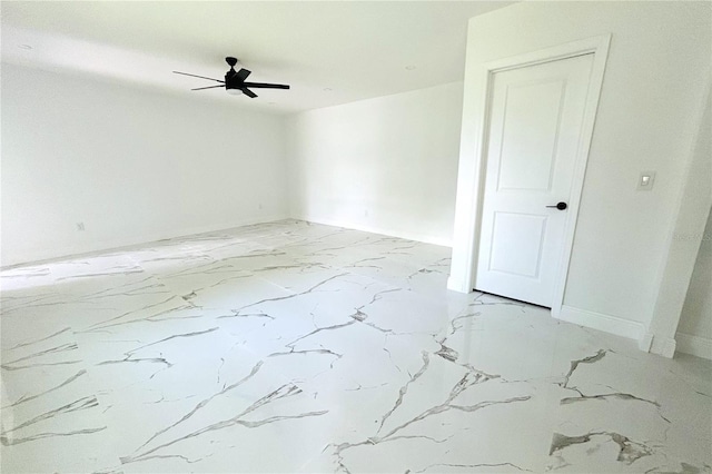 1109 N Obrien St, Tampa, FL 33607 - empty room featuring ceiling fan, light marble finish flooring, and baseboards