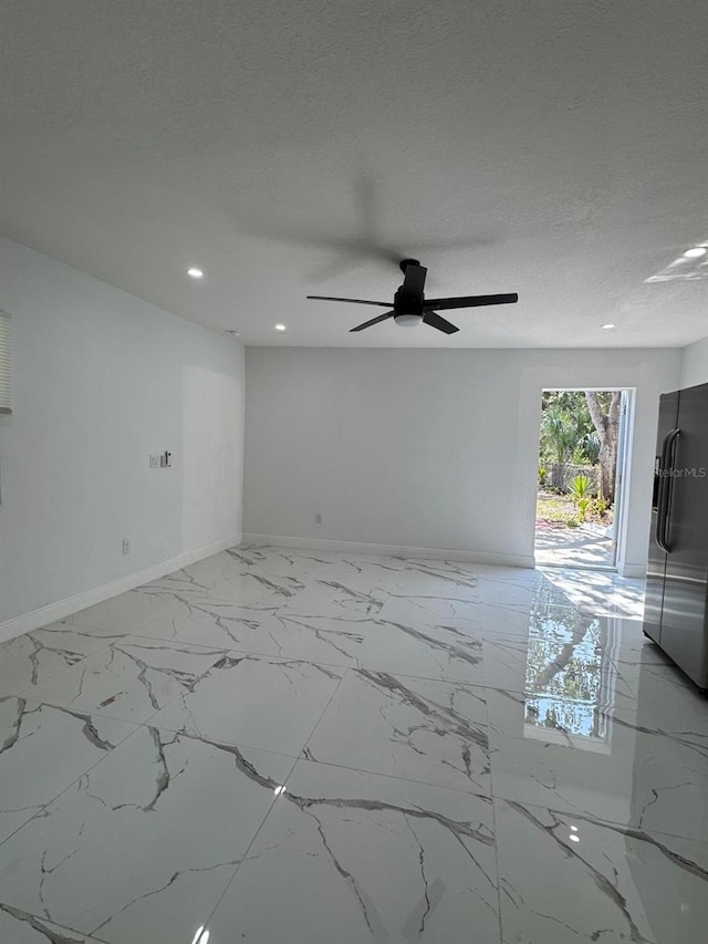 1109 N Obrien St, Tampa, FL 33607 - empty room featuring baseboards, light marble finish flooring, a ceiling fan, recessed lighting, and a textured ceiling