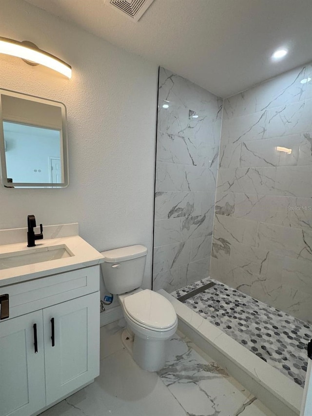 1109 N Obrien St, Tampa, FL 33607 - bathroom with marble finish flooring, toilet, vanity, a marble finish shower, and recessed lighting