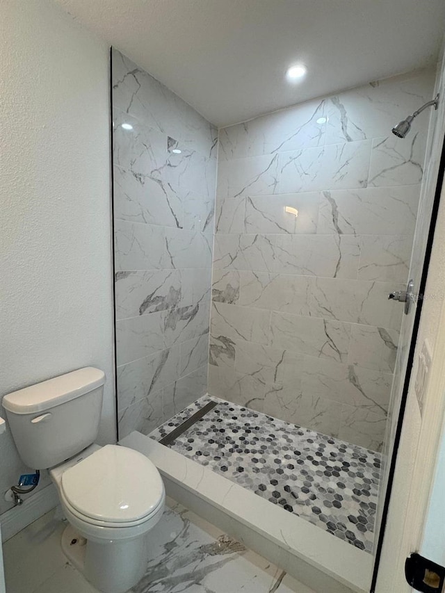 1109 N Obrien St, Tampa, FL 33607 - bathroom with marble look tile flooring, tiled shower, toilet, and recessed lighting
