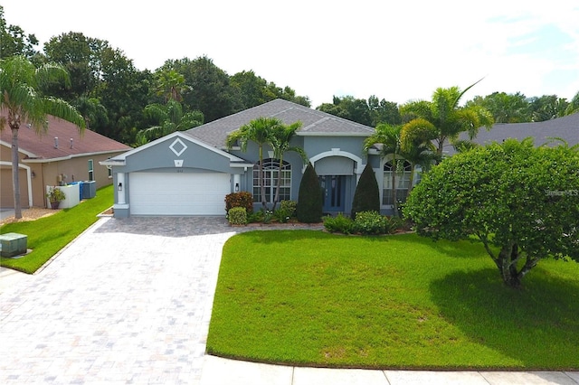 1842 Ridgelake Ct, Wesley Chapel, FL 33543 - view of front facade featuring a garage, stucco siding, a front yard, and decorative driveway