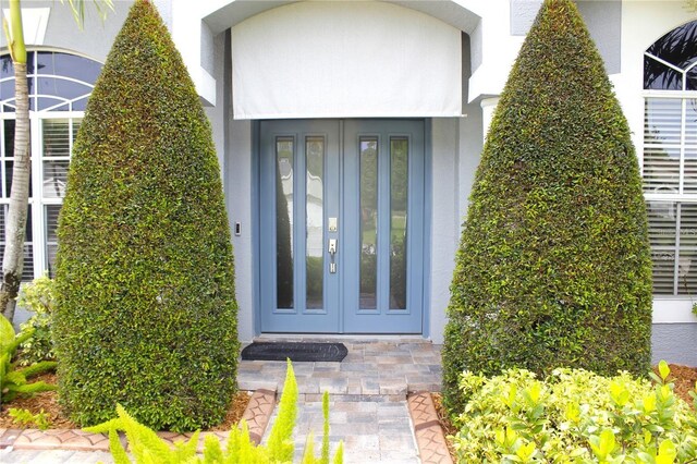 1842 Ridgelake Ct, Wesley Chapel, FL 33543 - entrance to property with stucco siding and french doors