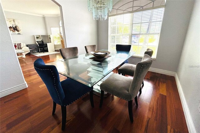 1842 Ridgelake Ct, Wesley Chapel, FL 33543 - dining area with arched walkways, crown molding, a chandelier, baseboards, and wood finished floors