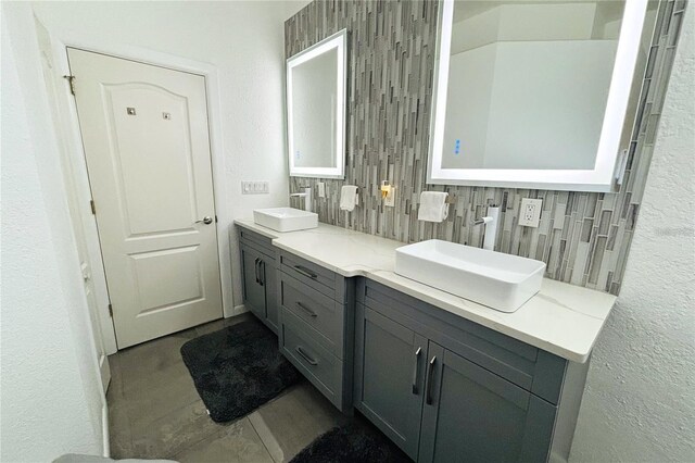 1842 Ridgelake Ct, Wesley Chapel, FL 33543 - bathroom with backsplash, double vanity, tile patterned flooring, and a textured wall