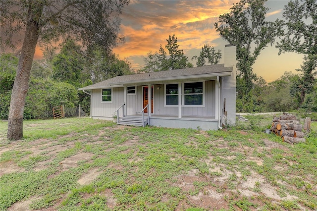 5290 Cyril Dr, Dade City, FL 33523 - view of front of home with a chimney, a porch, and board and batten siding
