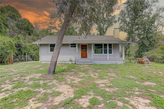 5290 Cyril Dr, Dade City, FL 33523 - view of front of home with a chimney, a porch, and board and batten siding