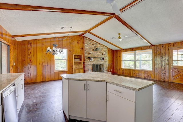 5290 Cyril Dr, Dade City, FL 33523 - kitchen featuring dishwasher, open floor plan, wooden walls, dark wood finished floors, and vaulted ceiling