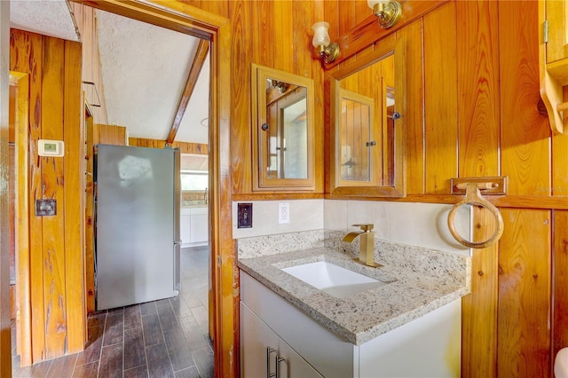 5290 Cyril Dr, Dade City, FL 33523 - bathroom featuring vanity, wood finished floors, and wood walls