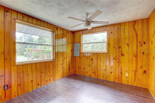5290 Cyril Dr, Dade City, FL 33523 - unfurnished room featuring electric panel, a ceiling fan, and wood walls