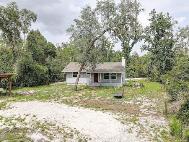 5290 Cyril Dr, Dade City, FL 33523 - view of front of property with a chimney and roof with shingles